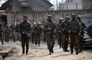 HAJIN, BANDIPORA, JAMMU AND KASHMIR, INDIA - 2016/02/04: A special operation group soldier runs for cover near the encounter site after heavy exchange of firing in Hajin Village of Bandipora some 35 Kilometers from Srinagar the summer capital of Indian controlled Kashmir. Three foreign militants of Lashkar-e-Toiba outfit were killed in an encounter between Government forces and militants, police said. (Photo by Faisal Khan/Pacific Press/LightRocket via Getty Images)