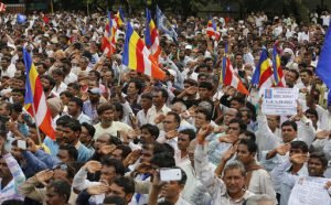 Members of India’s low-caste Dalit community salute the Indian flag they hoisted as they gather for a rally in Una, Gujarat state, India, Monday, Aug. 15, 2016. The Dalits have been protesting since four men belonging to their community were beaten while trying to skin a dead cow in July near this western Indian town. Videos of the four being stripped and beaten with sticks by men claiming to be cow protectors in Gujarat state had gone viral and sparked protests by Dalit groups across India. The Dalits, belong to the lowest rung of Hinduism's caste hierarchy. (AP Photo/Ajit Solanki)