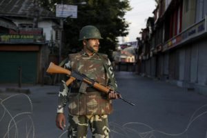 An Indian paramilitary soldier stands guard at a check point during curfew in Srinagar, India, Sunday, Aug. 14, 2016. Security has been beefed up across the Kashmir valley ahead of India's Independence Day which falls on Aug. 15. (AP Photo/Mukhtar Khan)