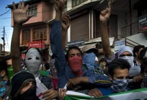 Kashmiri Muslims shout slogans against Indian rule during a protest in Srinagar, Indian controlled Kashmir, Saturday, July 30, 2016. Clashes continued as a curfew was still in place in parts of Indian-held Kashmir on Saturday, with shops closed across the region in response to a separatist call for a shutdown until Sunday amid outrage over the killing of a top rebel leader by Indian troops earlier this month. (AP Photo/Dar Yasin)