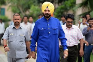 Former Indian cricketer and former member of parliament Navjot Singh Sidhu (C) walks from his car to address the media outside his residence in New Delhi on July 25, 2016. Sidhu's resignation as a Bharatiya Janata Party (BJP) MP has kickstarted speculation he is moving to the Aam Aadmi Party (AAP), which is rising in popularity in Punjab ahead of general elections. / AFP / MONEY SHARMA (Photo credit should read MONEY SHARMA/AFP/Getty Images)