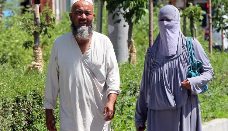 China bans beards and burkas in Muslim region - news live now